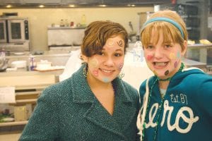 Although older Girl Scouts were working at the Girl Scout Carnival on Saturday, January 21, they still found time to have some fun and have their faces painted. Pictured here with dots and swirls are Wellesley Howard-Larsen (left) and Kia Brazell.