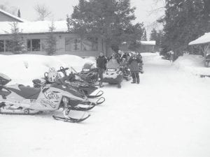 The Cook County Ridge Riders Snowmobile Club hosted another fabulous Fun Run on Saturday, February 4. There were 150 riders—from Cook County and far beyond—registered and on the trails, riding from Devil Track Landing to points up the Gunflint Trail. Top: Snowmobilers stretch their legs at Gunflint Lodge. Above left: There were fun games and raffles—a meat raffle, a balloon raffle and a raffle for cash. Ian McCumer (left) won $500 and Jerry Paine won $200. Upper right: Matt Schliep of Grand Marais won the grand prize $1,000. It was so much fun the Ridge Riders said they would do it again next year. Mark your calendar for the first weekend of Feb. 2013.