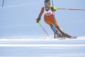 Above: Junior Signe Larson led the Cook County/Silver Bay ski team to a fourth place finish at the Section 7 Alpine ski meet held at Spirit Mountain on February 7. Larson finished 13th overall and is the only Viking to advance to the state meet. Right: Anders Zimmer powered his way down the course at Spirit Mountain, finishing 21st overall at the Section 7 alpine meet, and was just 49/100th from advancing to the state meet.