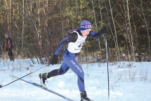 Above: Sophomore Levi Axtell displays beautiful cross country skiing technique as he races to a 32nd place finish at the Section 7 state qualifying meet. Right: Joey Chmelik, also a sophomore, showed a lot of determination as he powered his way to a 44th place finish at the Section 7 meet; and for the girls, Audrey Summers (far right) led the team with her 28th place finish at Giants Ridge, the site of the state qualifying meet.