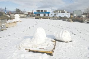 The cupcake snow sculpture in Grand Marais’ Harbor Park toppled over on Saturday, February 18 after warm winter weather brought about its rather early demise. The other sculpture left over from the Winter Tracks Festival at the beginning of February is still standing in the background.