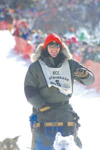 Frank Moe of MoeTown Kennels in Colvill, pictured here in the 2011 John Beargrease Sled Dog Marathon, is taking his dogs on a run to the State Capitol—snow or no snow. Special high-density plastic on the dog sled runners will allow passage over bare ground. Moe and fellow musher Adam Harju will be delivering petitions to the legislature in opposition to non-ferrous metals mining projects.