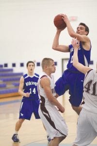 Far left: One defender just waves and the other Two Harbors player makes “monkey lips” at David Bergstrom but it doesn’t stop David from scoring 2 of his 21 points against their usually tough North Shore rival. Above: Senior guard Hunter Farley embodies what a true teammate is. Although he rarely plays, Hunter started against Two Harbors and scored the Vikings' first two points off of the opening tip-off. Head Coach Mitch Dorr said he would treasure that memory for years to come. Left: Senior forward/ center Dylan Quaife drove for 2 of his 17 points against the Agates. Dylan finished 4th in the conference in scoring with a 16.9 point per game average.