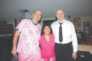 The Bold, the Bald and the Beautiful. Victims/volunteers Don Kufahl (left) and Dennis Neitzke shaved their heads—in front of a cheering crowd at Windigo—to raise money for the National Breast Cancer Foundation. Kufahl raised $1,000 and Neitzke raised $2,500. They are pictured here with MFAC honoree Ana Genz-Wall.