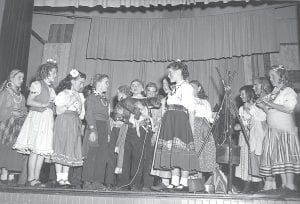 Only a few of the fourth-grade students in this photo are known to Janet Schuster Nagy, who shared it with us for this Historical Reflection. Janet recalls that the third girl from the left is Ginger Anderson. Janet is next to the child holding the dog. They were all on stage for an operetta directed by Mrs. Wilcox, the music teacher. Janet said Mrs. Wilcox was originally from New York and she was very talented. The operetta was about gypsies.