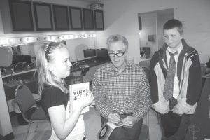 During his appearance at the Arrowhead Center for the Arts, Stuart McLean of CBC Radio’s Vinyl Café called a couple of young helpers to the stage to assist with a prize drawing. Afterwards, he greeted them in his dressing room to autograph a Vinyl Café CD collection for them. (L-R) Sylvia Berka, Stuart McLean, Sam Sietsema.