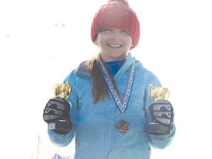 Reilly Wahlers holds two of the three first place trophies she recently won racing in the Region 1 Planet Cup series. Reilly beat about 80 girls from the Midwest to claim the overall trophy and the slalom and giant slalom events. She is the daughter of Lisa and Max Wahlers of Grand Marais.