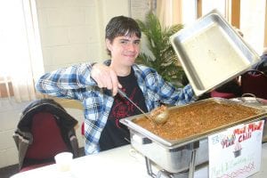 Trevor Delamater stirs the unique chili entered by Mark D. Consulting. The “It’s a Mad, Mad, Mad, Chili” included several types of chili peppers and a hint of chocolate.