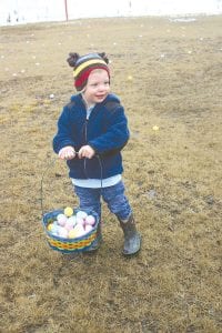 Far left: Despite cold weather and soggy grass, Jake found plenty of candyfilled eggs to fill his basket at the Kids Plus Easter Egg Hunt. Above: The Peep eating contest was enjoyed by on-lookers—we’re not so sure about the participants. Molly had a tough time with the sweet candy bunnies. Left: With mud boots and rain coat, this little guy was ready to find some eggs in the drizzle.