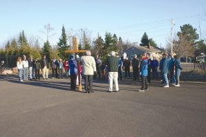 Left: A prayer was offered at the Cook County Community Center where Life in Christ Lutheran Church meets. Warm weather made the worship a pleasant experience.