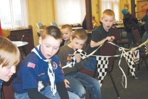 “Wow! Look at those cars go!” The annual Pinewood Derby was held at St. John’s Catholic Church on Saturday, March 31. Above: (L-R) Lucas Sheils, Noah Furcht, Finn Furcht and Preston Benedix. Left: Holding the trophies they won are, (L-R) Caleb Benedix, Vaughn Swindlehurst, Tristen Walton, and Riley Tarver.