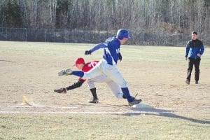 Left: Sprinting with everything he had, Colin Everson beat out a single to first base in the Vikings' first game of the season against Moose Lake-Willow River. The Vikings won the contest 3-2 in the 7th inning on the last play of the game. Above: Joe Borud created a small dust storm as he slid into home plate and beat the throw to the catcher.