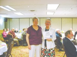 The Grand Marais Lions Club recently celebrated its 60th birthday at a charter night dinner at the Grand Portage Lodge. At the event, Lioness President Katie Anderson presents the Lioness of the Year award to Judy Siegle.