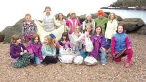 Preparing for Earth Day. In March, Cook County Girl Scouts— the Daisy and Brownie troops— conducted a beach sweep. After the messy work, the girls posed for a photo with some of the trash found on the beach and under boulders on Grand Marais’ east bay.