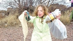 Far left: Brownie CeCe showed that she lives by the Girl Scout promise to “help people at all times” by picking up some unpleasant trash!