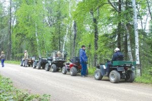 Members of the Cook County ATV Club pause to enjoy the scenery and socialize during a ride on a U.S. Forest Service road last June.