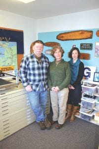 (L-R) Vilnis Neilands, Betsy Perry, and Carin Gulstrand at E.R. Perry Signs & Engraving on 1st Avenue West in Grand Marais. Vilnis and Betsy have taken their business nationwide with the help of UPS and the Internet. Their signs can be found under the ocean, on the highways, and even in space, and their customers include the U.S. Air Force, FEMA, the CIA, American Airlines, and a space transportation company called SpaceX.