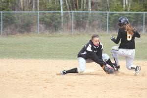 Eyes closed but full of resolve, CeCe Schnobrich gets ready for a collision as she applies the tag-out to the Marshall player trying to get to second base.