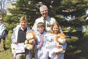D.A.R.E. instructor Leif Lunde with the students who helped spread the D.A.R.E. message this year with an essay or a poster. (L-R) Lynden Blomberg wrote a winning essay. Masen McKeever made a colorful D.A.R.E. poster, earning 9th place in the state and a medal. Elsa Lunde also wrote a winning essay. The essay winners were presented a Daren the D.A.R.E. lion, the D.A.R.E. program mascot.