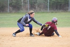 Left: Quick as a cat, CeCe Schnobrich delivers the tag to the McGregor runner trying to reach second base. Above: Showing a great amount of concentration and determination, Lexi Palmer takes an at-bat against the McGregor Mercs.