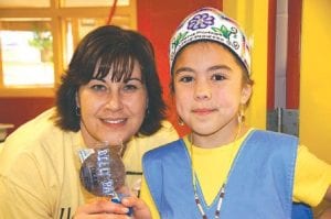 Dana Logan (left) from the powwow committee and Junior Princess Shaelynn Novitsky, one of six powwow royalty, enjoy a dilly bar, generously donated by the new owners of the Grand Marais Dairy Queen.