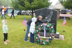 After the ceremony, veterans and their friends and families visited on the courthouse lawn. This mother read the words on the Cook County Veterans Memorial and talked to her little girls about the special meaning of the day.