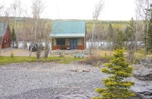 Although guests at Hollow Rock Resort will likely spend most of their time outside, the lovely cottages are wonderfully welcoming. This photo of the Moose cabin is taken from atop Hollow Rock.