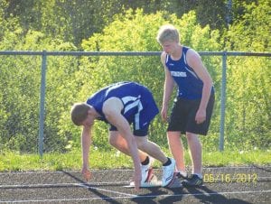 Junior Peter Warren led the boys’ team, finishing 2nd in the 100 with an 11.69 PB and placing 6th in the 200 at 24.64. His brother, Noah Warren, pictured here holding the block for Peter, trailed his older brother with a fine 27.2 in the 200.