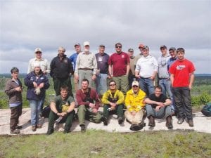 A historic trail near Chik Wauk Museum is open once again, thanks to a volunteer trail-clearing crew. Taking a break from their labor on May 30 for a photo are (L-R, front) Kathy Lande, Sally Valentini, Jesse Limanen, Rich Kujawa, Ben Karon, Jim Morrison, Greg Gecas. (L-R, back) Dick Gillespie, John Scott, Don Kufahl, Dan Fitzgerald, Greg Truex, Mike Mansson, Arden Byers, Mike Henderson, Grant Hopke, Nick Asay, Chris Steele, Mike Swenson. (Not pictured: Michael Valentini)