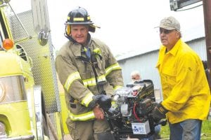 Above: Firefighting is hard work—Maple Hill firefighters Doug Klein (left) and Greg Olson carry a pump to the creek that provides water for fire hoses.