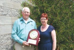 Arrowhead Electric Cooperative Inc. General Manager Jeanne Muntean presented outgoing Director Wayne Anderson with a lovely clock in recognition of his service on the cooperative board.