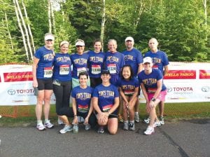 A hearty group of runners participated in the Garry Bjorklund Half Marathon in Duluth on Saturday, June 16 in honor of County Attorney Tim Scannell’s triumphant recovery after the courthouse shooting in December. The team was conceived and organized by Assistant County Attorney Molly Hicken. Back row, L-R: Kerrie Fabius, Molly Hicken, Mary Hicken, Liza Hicken, Jeff Hicken, Dave Gilmore, Kyle Oberg. Front row, L-R: Theresa Oberg, Amy Lacina, Jeanne Smith, Jamie Block. Also on the team were Hilja Iverson, Kaja Yirkovsky, Aimee Venne, Brian Silence, Chris Hegg, Alex Hegg, Tony Hegg, Mark Falk, Kieran Scannell, Lynn Swanson, Monica Schnobrich and Tim Scannell. Their support team consisted of Ann Hegg, CeCe Schnobrich, and Lars Scannell.