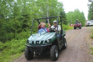 Jean and Bill Cherwin of Chicago and Devil Track Lake take off on the ride in their side-by-side ATV.