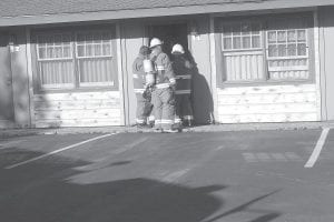 Grand Marais firefighters investigate the cause of smoke in unit No. 11 of the Grand Marais Gateway Lodge on Sunday, June 24. The cause of the smoke was an overheated bathroom ceiling fan.