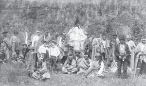 Recently invited to speak at the Linnell Family Association Reunion at the Grand Portage Lodge on Saturday, June 23, Grand Portage Band of Lake Superior Elder Billy Blackwell shared some of the American Indian history of the area. Blackwell noted a long history of cooperation with the Linnell family and other residents of the long-gone town of Mineral Center. He said not all people who came to Grand Portage were respectful of the land and its people and he spoke of conflicts with the government. Blackwell shared this photo with the Cook County News-Herald of a friendly encounter. The picture was taken at the foot of “Rose Hill” in about 1885. The note on Blackwell’s historic photo reads, “The white men had just come by boat from LaPointe (Ashland) Wisconsin with the treaty issue. The Indians stopped their game of lacrosse to have their picture taken by the photographer. They have the blankets on given to them by the Indian agents.” Blackwell adds that Grand Portage Tribal Leader Mike Flatte is pictured, sixth from the left in the back row.