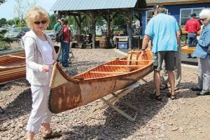 The North House Folk School’s Wooden Boat Show on June 22-25 was once again well attended by fans of boating and chowder and traditional crafts. Far left: Campus visitors check out a birch bark canoe. Above left: Everyone has a boat story to share! Above middle: North House Director Greg Wright shouts out what everyone had been waiting to hear, “Chowder’s ready!” Above right: One of many of the talented craftsmen working on campus during the boat show was Roger Abrahamson, who carved one-of-a-kind wooden bowls.