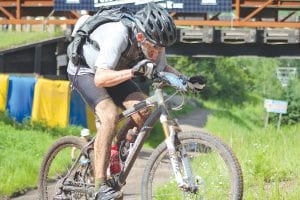 Above: The Lutsen 99er mountain bike race had a 99-mile and 39-mile event on Saturday, June 23. Both races ended with a tough uphill climb to the finish line. Patrick Sheedy was the first one across the finish line in the 39er. Sheedy finished in 2:27:40.15. Right: Both races started at Bridge Run at Lutsen Mountains Ski Hill, following a pace car down the Ski Hill Road, along Highway 61 and up the Caribou Trail. On the Caribou Trail, the pace car pulled off and the race was on!