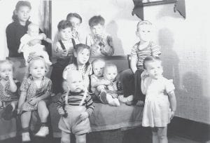 This photo is believed to have been taken at Jack Heiskari’s second birthday party, in about 1943. Standing in front are Jack Heiskari and Ginger Anderson. (L-R, seated) Karen Linnell, Sandra Linnell, Mary Mable Powell, two unidentified babies, and Larry Anderson. (L-R, back) Myrtle Powell holding another unidentified baby, Michael Powell, Milton Powell, and Andy Powell. Milt remembers being Jack’s babysitter. But he does not remember who the three babies in the photo belong to. Can anyone identify them?