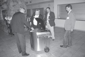 Above: Biomass energy is used extensively in Sweden. (Above, L-R) On hand at the inauguration of Wolf Ridge’s new system were Jonas Hafström, Swedish ambassador to the United States; Per Carlsson, owner of ABioNova, the Swedish company that produced the boilers; and Pete Smerud, Wolf Ridge executive director. Hafstrom was presented with a WoodMaster wood-pellet-fueled barbecue grill manufactured by Northwest Manufacturing of Red Lake Falls, ABioNova’s American distributor.