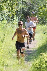 Local runners Derek Smith (front) and Joey Chmelik looked strong on the trail. Smith finished in 11th place in 45:37.3 and Chmelik was 12th coming in at 45:46.1.