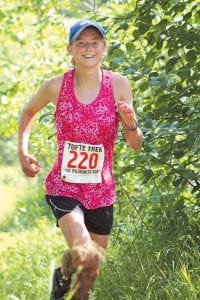 Kaelyn Williams finished first among the women runners and looked like she hadn’t struggled at all through the hills and tough footing.