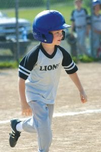 Above: Lion Brayden Schmidt heads for the base in a recent Parent Pitch game.