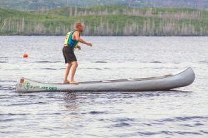 Gunnel pumping is one of the most interesting events in the canoe races. This young man shows great form in the crazy contest that has racers standing on the gunnels of the canoe and rocking to move forward. None of the women gunnel pump racers completed the race as the wind picked up and pushed them off course and they were not able to get through the race buoys. Everyone had fun trying though!