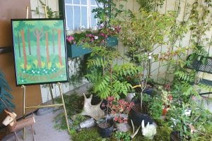 Above: “A Woodland Garden,” the theme of this year’s Grand Marais Garden Club flower show on July 20, was a fitting theme for Cook County, with flowers abounding all around the forest. Left: Jean Bratsch used a mixture of cultivated and wild flowers with cedar in her arrangement.