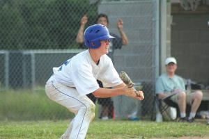 Upper left: Ritchie Furlong gets ready to lay down a bunt in the first game of a double-header against Brookston Friday, July 20. The North Shore American Legion team split with Brookston, losing the first game and winning the second. Lower left: Joe Borud pitched well in the second game for the win. Above: Lucas Phillips ran in from right field to cover third base and put a nice tag on the Brookston runner trying to advance on a double steal.