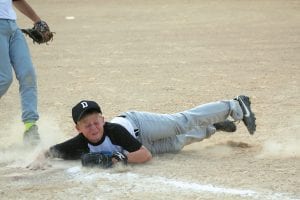 Little Leaguer Dillon Sjogren scooped up a hard hit ball and dove to first base just ahead of the runner for a well played out. Sjogren also got some key hits in the game against the Cubs to help seal a win for his Dodger team.