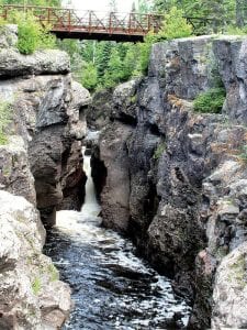 A 37-year-old Duluth woman and her dog were swept into the Temperance River on Saturday, July 21. The woman fortunately caught herself on a log in a pool about 200 - 300 yards above this multi-use bridge across the river. Lake County Search and Rescue worked with Cook County emergency crews to rescue her and her dog.