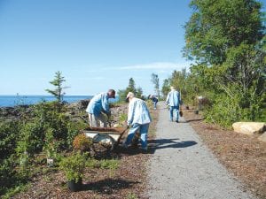 Twenty-eight volunteers installed 75 plants in under two hours along the trail leading to Father Baraga’s Cross in Schroeder on July 28. They were sprucing up the area in preparation for a rededication ceremony to be held Sunday, August 5 at 3:00 p.m. Father Baraga made a historic trip across Lake Superior in a storm in the 1800s, landing at what is now the mouth of the Cross River, where he and his companion erected a cross thanking God for their survival. He was known to some as “the snowshoe priest.” The public is invited to the rededication ceremony.