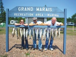 Sabra Heimerl, Justin Clark and Mike Brobeck with their catch on July 31. The anglers were aboard Secret Lures with Captain Jerry Skarupa. They caught 12 trout and eight salmon.