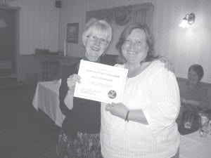 Lioness Judy Siegle presents Michelle Korst with the 2012 Lioness of the Year award at the Grand Marais Lions Club and Lioness Club Charter Night Dinner last May.